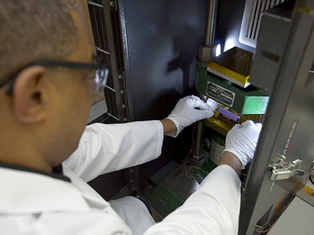 Laboratory technician testing a battery