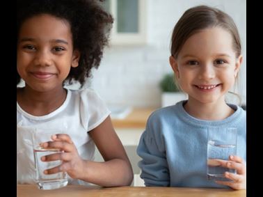 Two kids with glasses of drinking water tested with at-home testing kits from Element